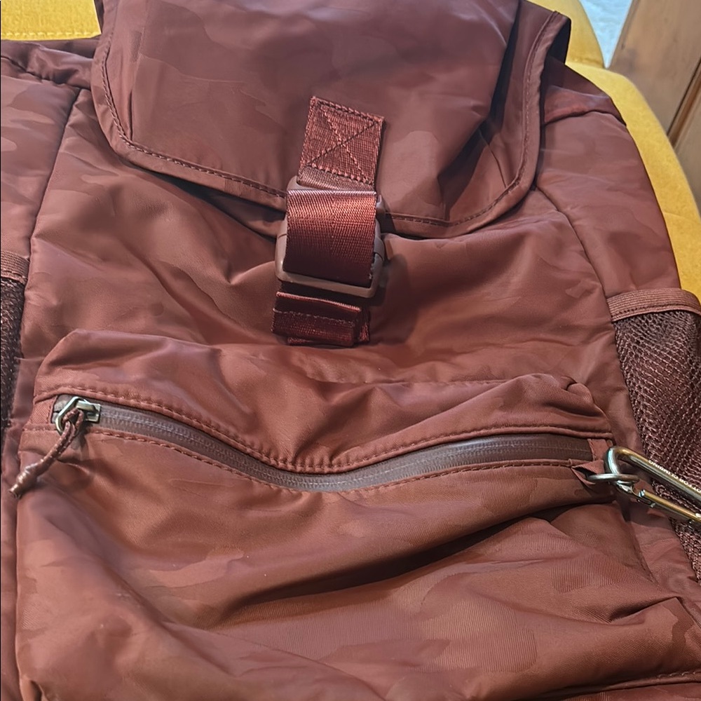 Stylish large Athleta Burgundy Backpack with zippers and padded back.
